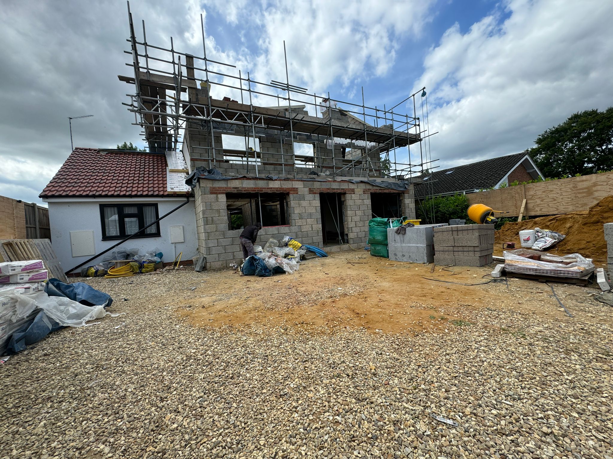 Two-storey blockwork shell rising with scaffolding