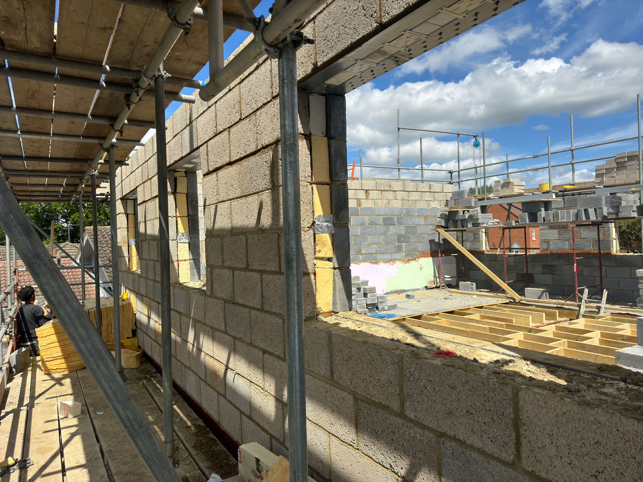 First-floor blockwork walls with window openings and scaffolding